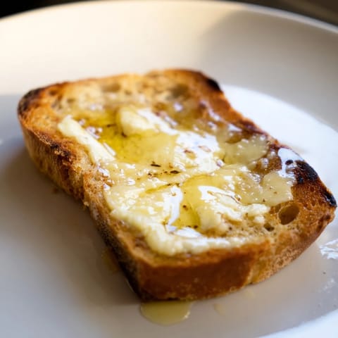 A close-up of a crispy Truffle Grilled Cheese sandwich, melted cheese oozing between buttery bread slices.