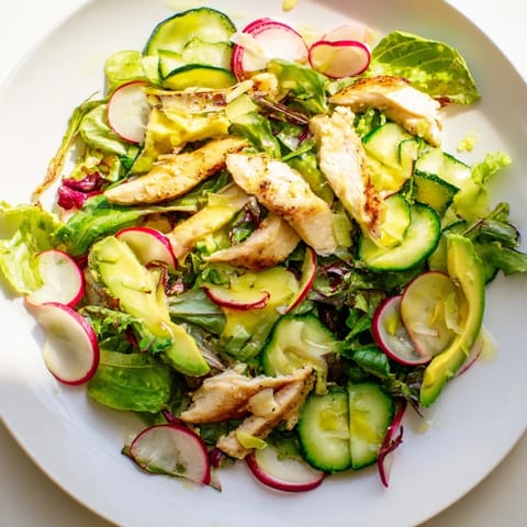 A close-up of the Spring Detox Chicken Salad shows juicy avocado and crisp vegetables tossed with tender chicken, perfect for a light, nourishing lunch.