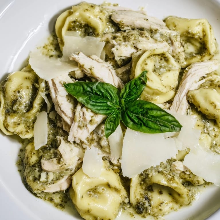 Comforting Creamy Pesto Tortellini Skillet on a skillet with Parmesan, ready for a family dinner on a wooden table.