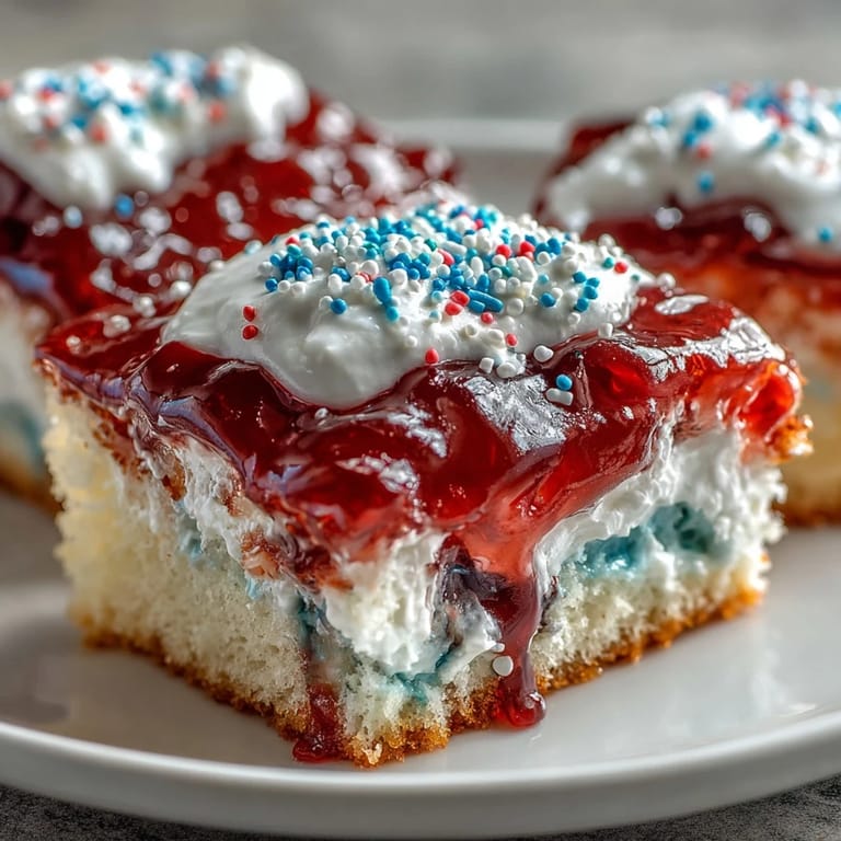 Decadent, chilled Red White Blue Poke Cake ready for summer celebrations.