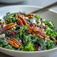 Warm Kale Salad With Maple Mustard Dressing, showing vibrant greens and crunchy toppings.