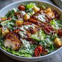 Fresh, crisp Romaine Caesar Bowl topped with golden croutons and shaved Parmesan, ready to serve.
